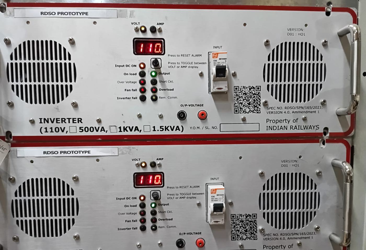 Two stacked inverter faceplates with red borders reading 110 volts