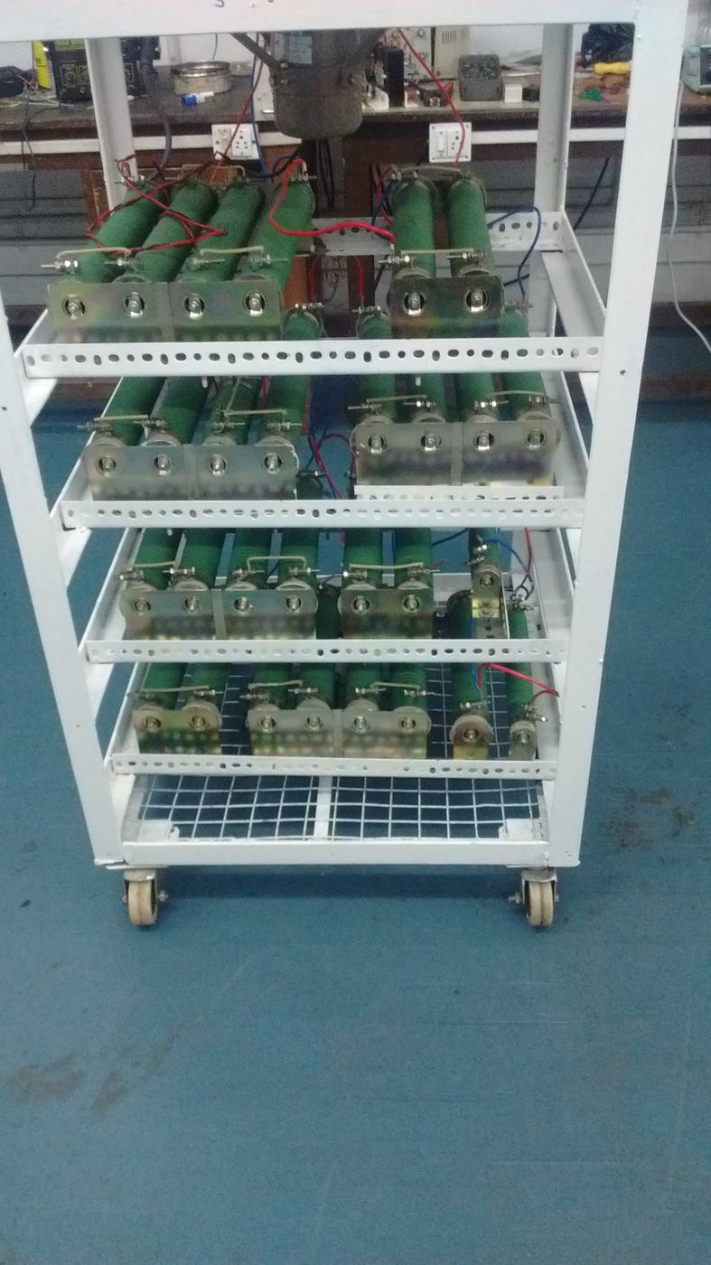 White rack holding rows of resistive load modules on shelves