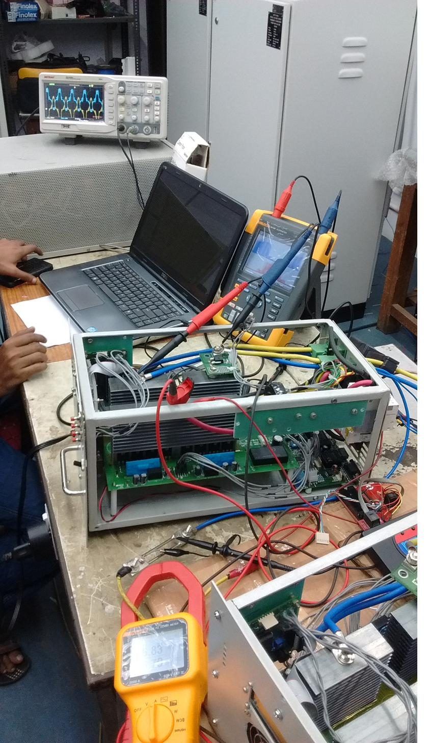 Inverter power stage with heat-sinked switches, gate-driver and control boards, wired to a Fluke ScopeMeter and laptop